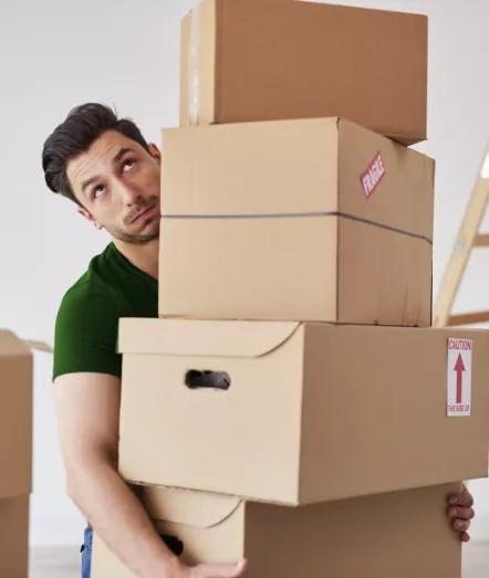 Man holding stacked cardboard boxes